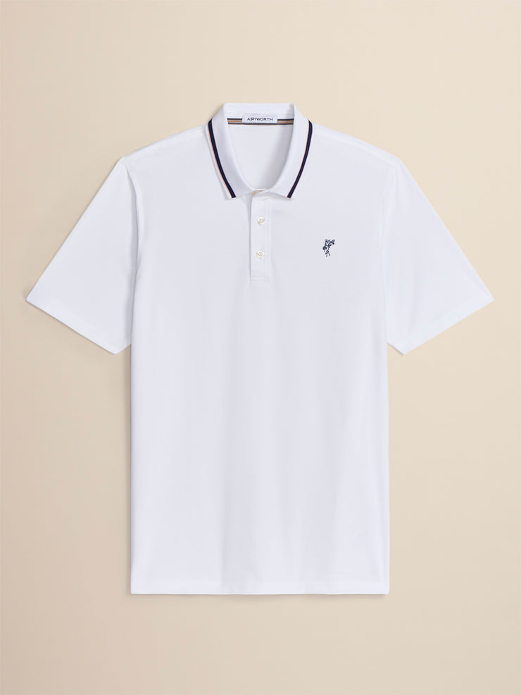 White polo shirt with black trim on a beige background