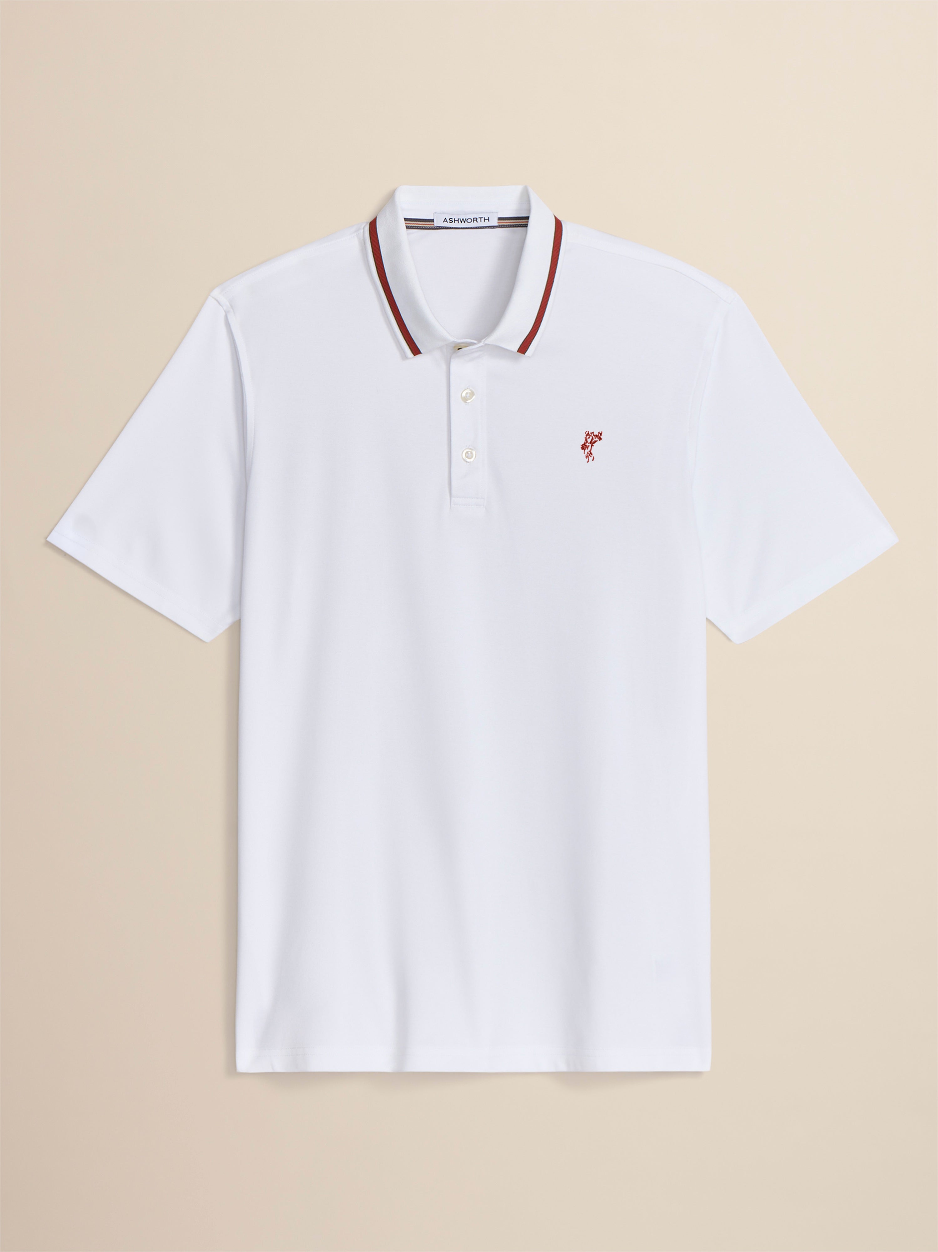 White polo shirt with red accents on a beige background