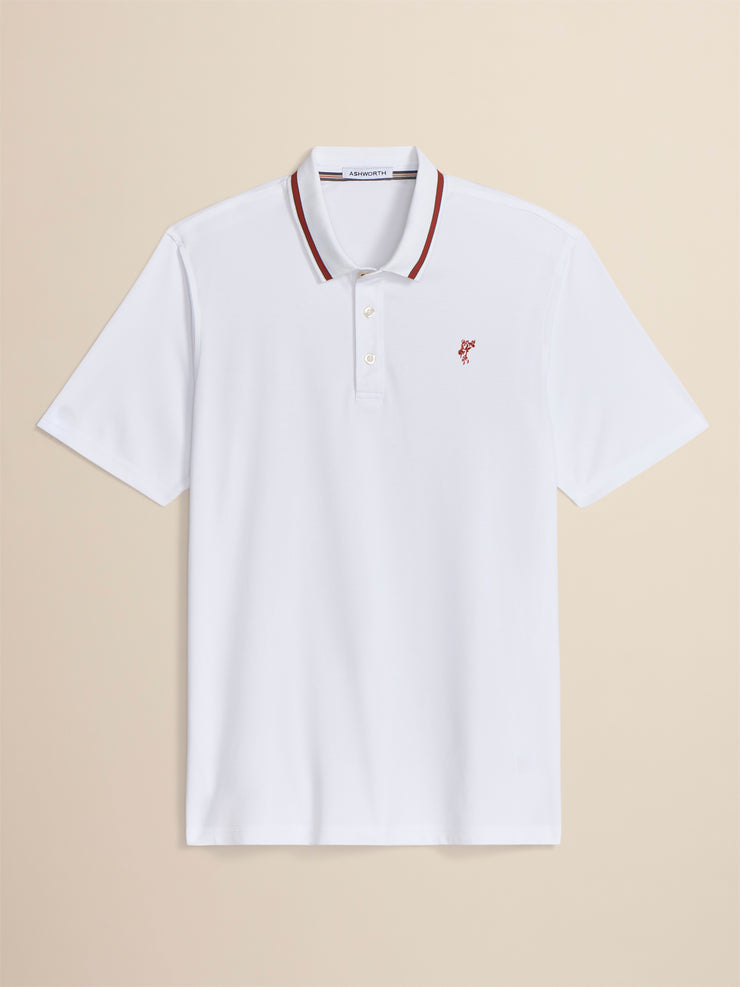 White polo shirt with red accents on a beige background