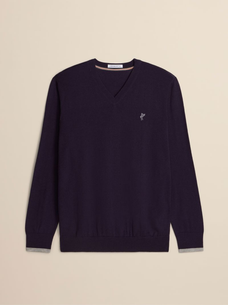 A dark purple v-neck knit sweater with a small embroidered logo on the left chest, displayed flat against a light beige background.
